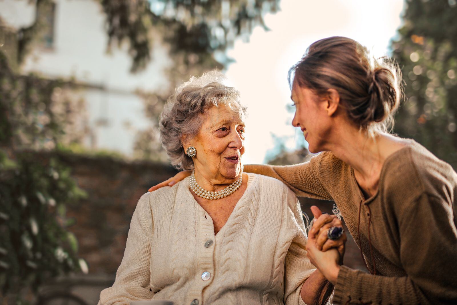 Older woman smiling with her adult daughter